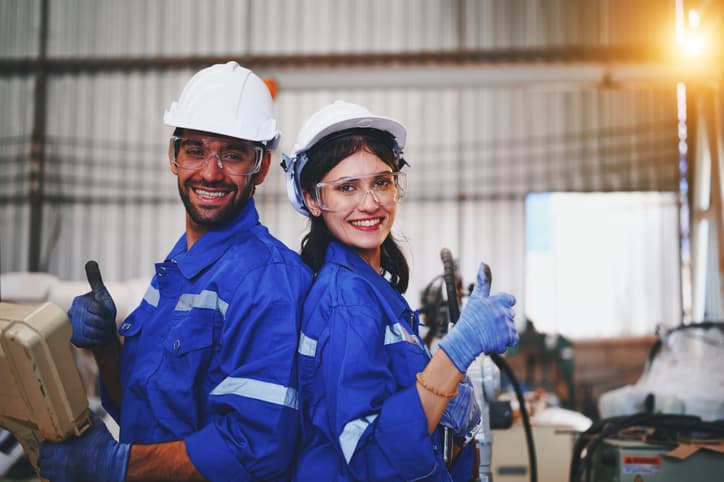 smiling male and female ZEN Bearings workers in a warehouse