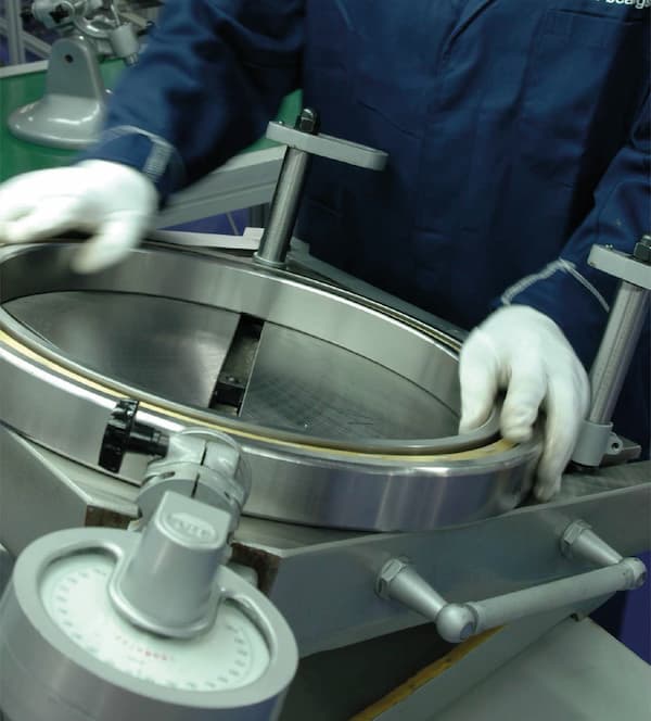 Factory worker handling a bearing
